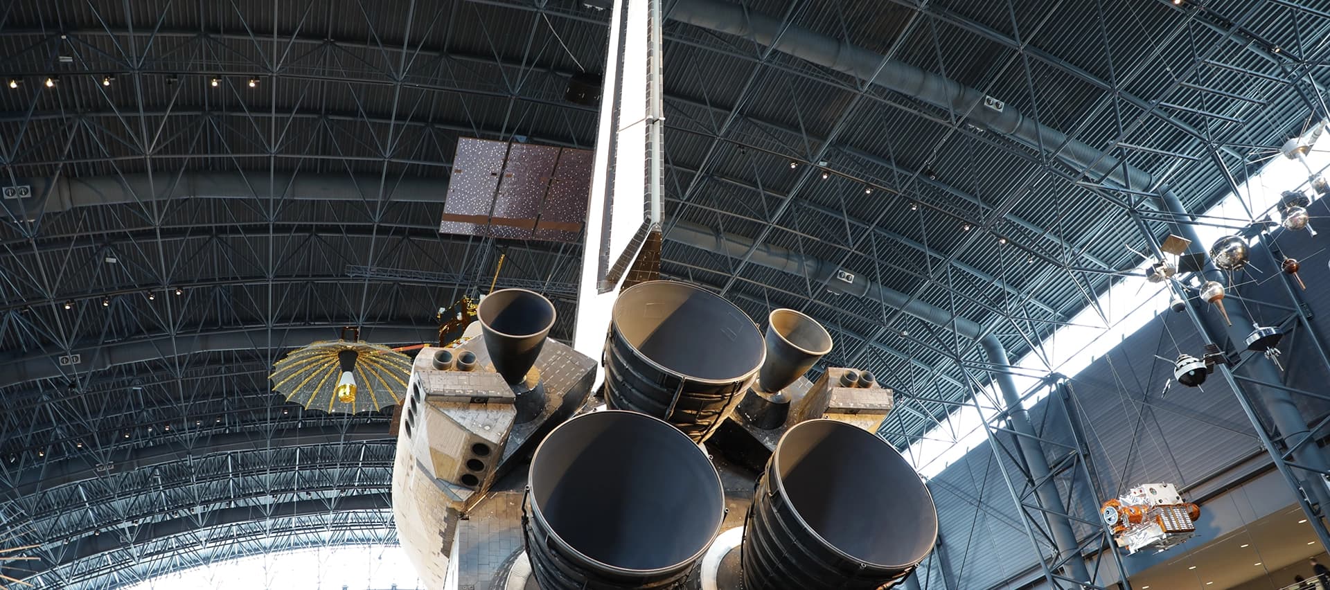 A close-up of a space shuttle's engines, showing the importance of precision bolting in aerospace engineering.
