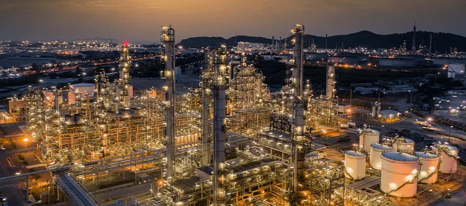 An overview of an oil and gas refinery at night, showing how large these torque jobs can be.